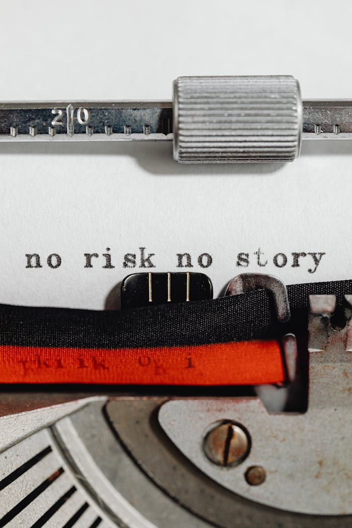Close-up of a vintage typewriter with a motivational phrase 'no risk no story' typed on paper.
